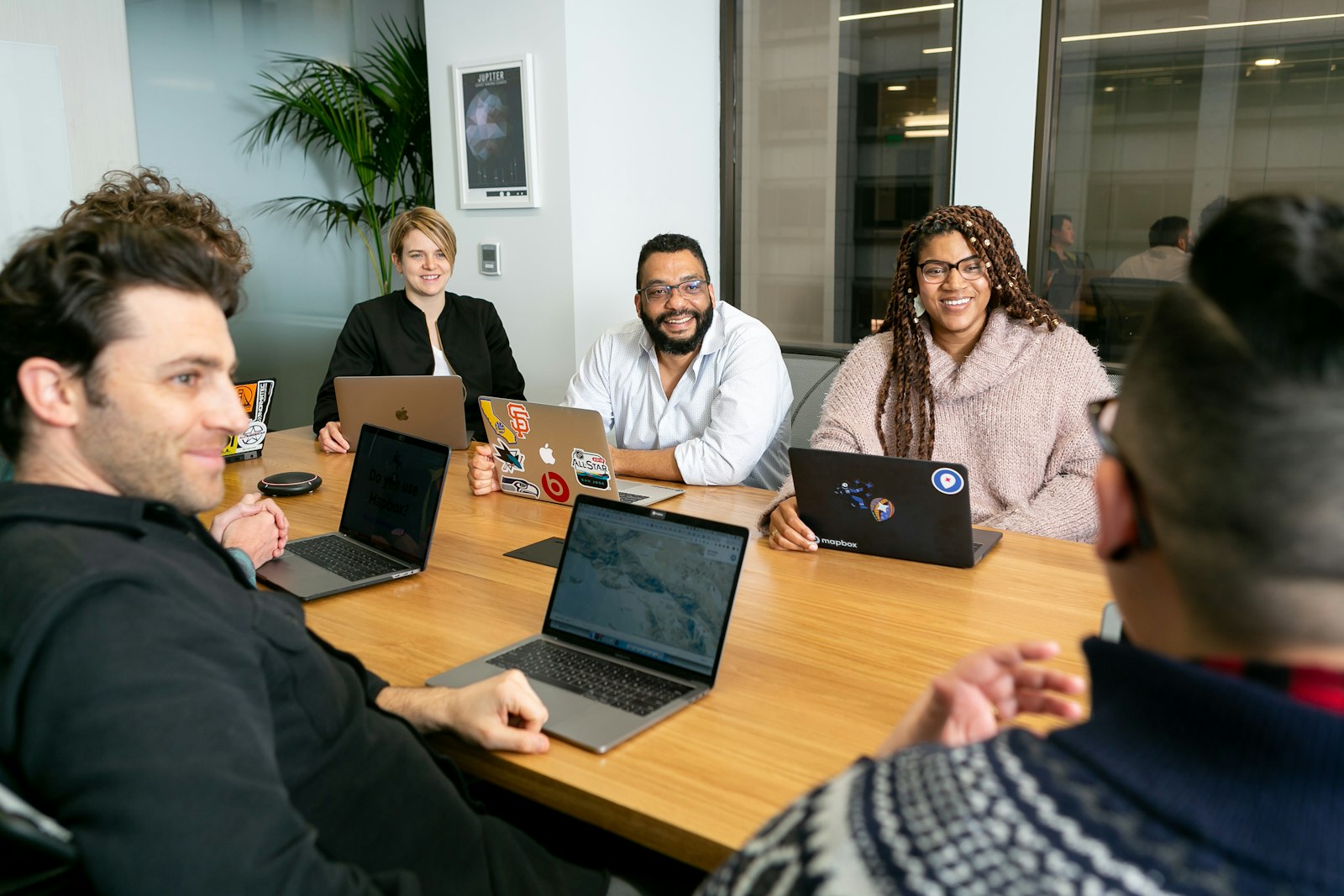 Sales team discussing the B2B lead generation process around a meeting table